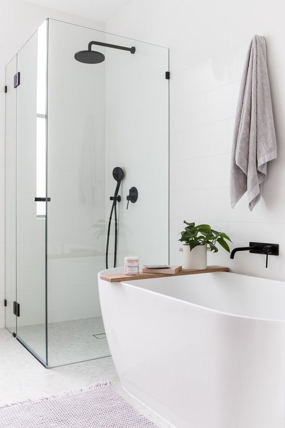 Airy Bathroom Design with Glass Enclosures and Black Accents