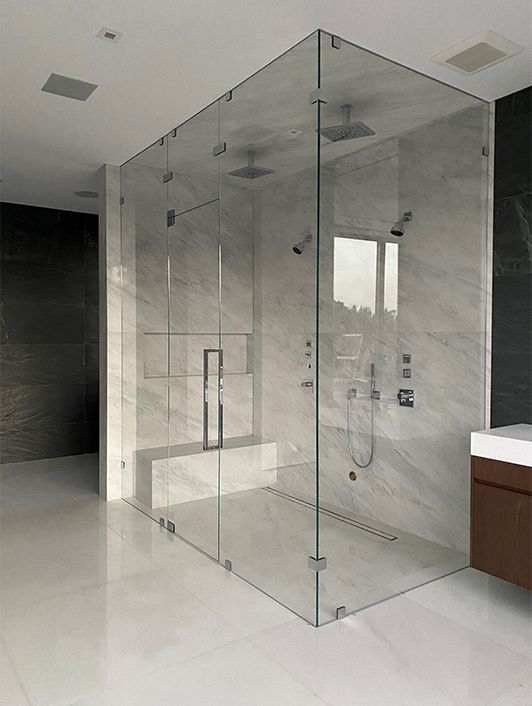Minimalist Marble Bathroom with Glass Shower and Bench