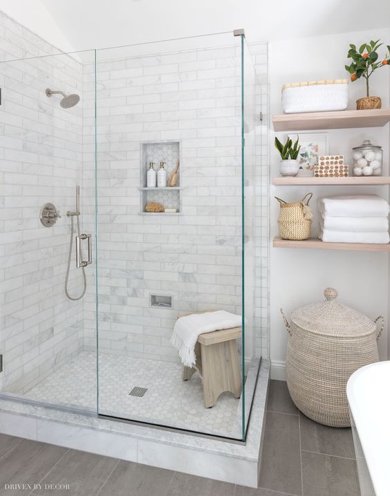 Neutral Farmhouse Bathroom with Wooden Shelves and a Glass Shower