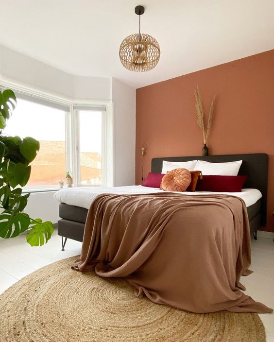 Bohemian Bedroom with Terracotta Walls and Bold Accents