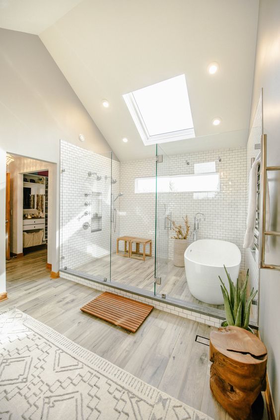 Cozy Attic Bathroom with Skylight, Glass Shower, and Bathtub Area