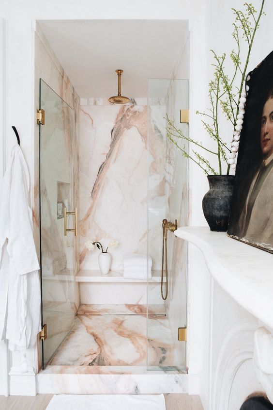 Bathroom with Pink Stone, Glass Shower, and Brass Fixtures