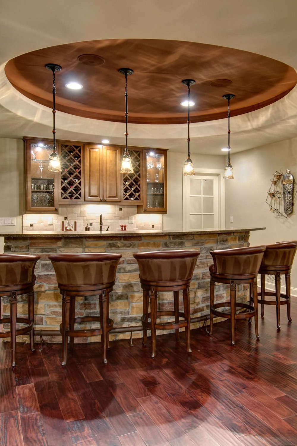 Basement Bar with Warm Wood Cabinetry and Light Countertops