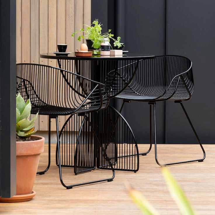 Modern Balcony with Black Bistro Seating and Wooden Accents