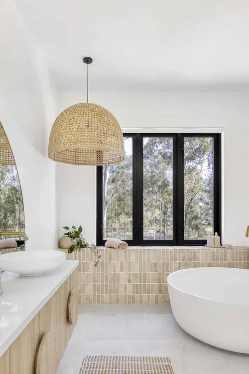 Beach Bathroom with Tan Tiles and Round Tub