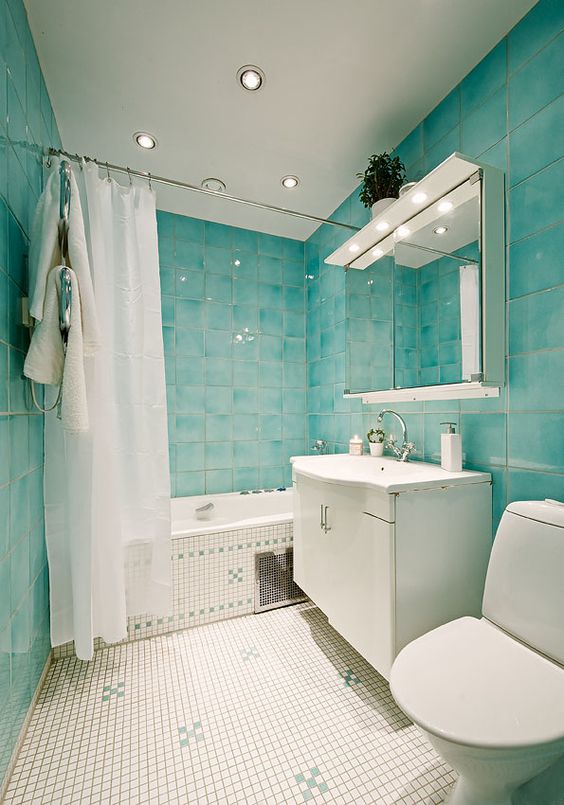 Bathroom with Turquoise and Neutral Tiles and Built-In Lighting