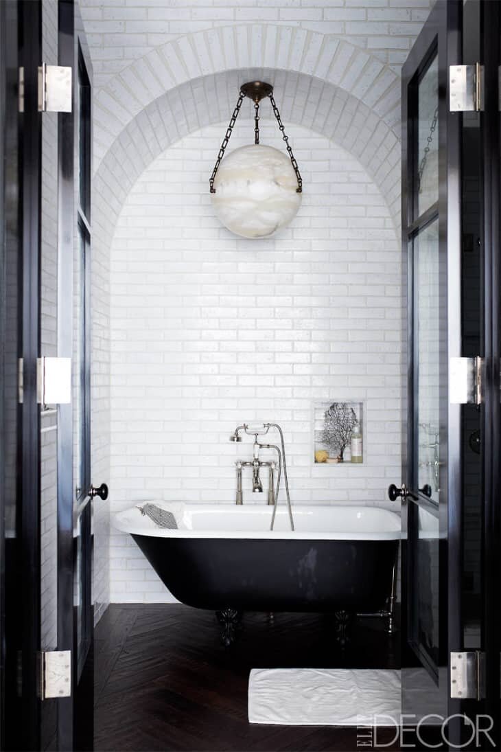 Compact Bathroom with Industrial Fixtures and Checker-Tiled Flooring