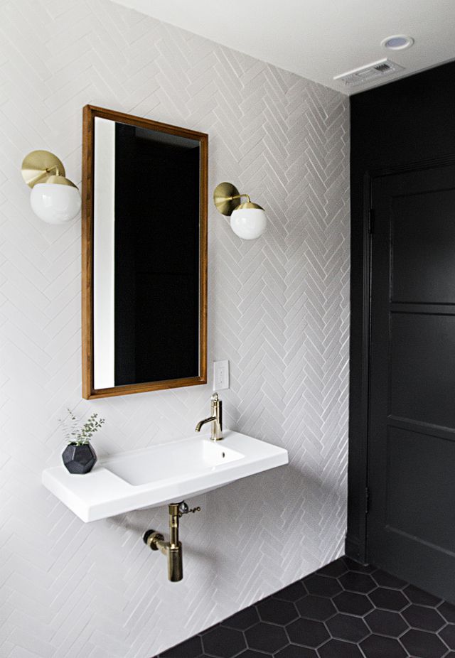 Minimal Bathroom with Textured White Walls and Matte Black Accents
