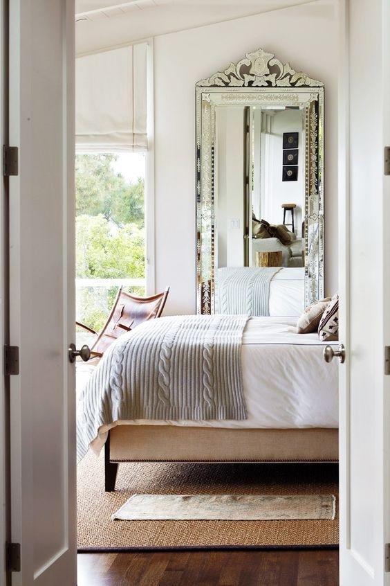 Bedroom with Double Curtains and a Large Mirror