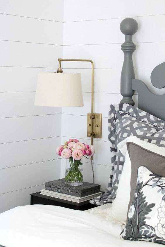 Bedroom with Elegant Gray Drapes and Wall Sconces for Ambient Lighting